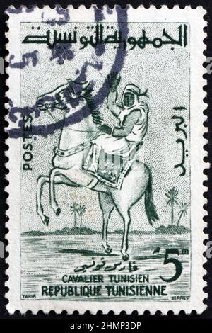 TUNISIA - CIRCA 1959: a stamp printed in Tunisia shows Tunisian horseman, circa 1959 Stock Photo