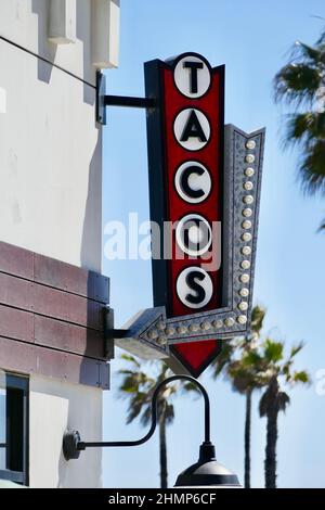 vertical wall hung TACOS sign in a retro style Stock Photo