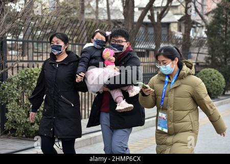 Beijing, China. 11th Feb, 2022. The spectators of the Winter Olympic Games wearing face masks seen preparing to enter the competition venues to watch the competition under the leadership of the staff.In order to prevent the spread of covid-19 and protect the health and safety of athletes and spectators, the 24th Winter Olympics did not sell tickets to the public, but organized some spectators to watch the games on site. Seven days after the Games began, not a single person in the audience had contracted Covid-19. Credit: SOPA Images Limited/Alamy Live News Stock Photo