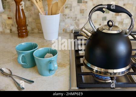 preparing a hot cup of tea in the kitchen Stock Photo