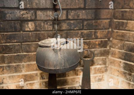 Cast iron cookware on colonial hearth Stock Photo - Alamy