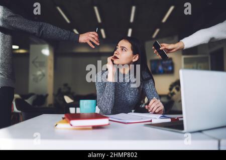 Busy assistant speaking on mobile phone in office Stock Photo