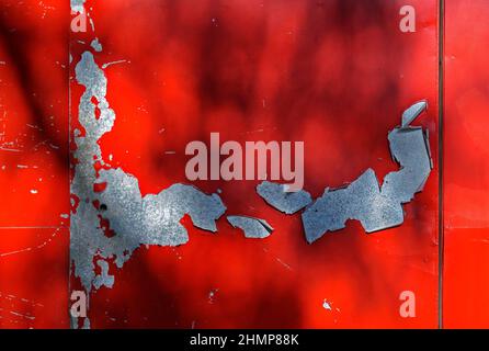 Damaged red metallic surface with peeling paint Stock Photo