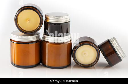 A set of different aroma candles in glass jars on a white background. Scented handmade candle. Soy, wax and paraffin candles. Stock Photo
