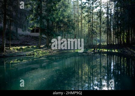 the concept of a healthy lifestyle is to breathe fresh clean forest air and enjoy catching the magical azure colors of the water at sunrise or sunset Stock Photo