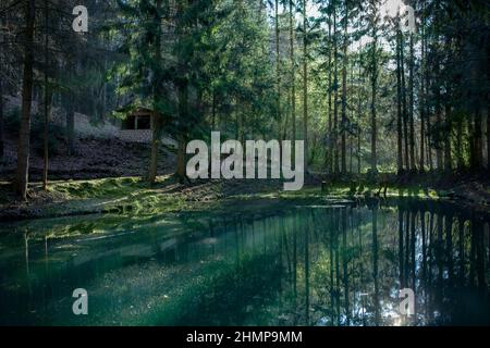 the concept of a healthy lifestyle is to breathe fresh clean forest air and enjoy catching the magical azure colors of the water at sunrise or sunset Stock Photo