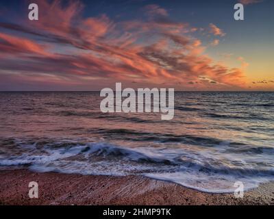 A minimalist shot to simply showcase the sunset afterglow and waves on Brighton Beach for an ultimate tranquil feel. Stock Photo