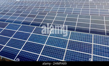 Aerial drone view flight over solar panels on sunny day close-up. Photovoltaic Stock Photo