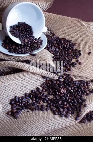 coffee cup and coffee beans on natural textile background Stock Photo