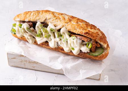 Baguette Asian fusion vegan sandwich with fermented and fresh vegetables on textured white Stock Photo