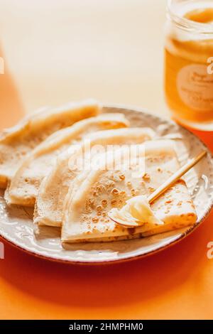 Ghee butter in glass jar and pancakes on table. Healthy eating, breakfast Stock Photo