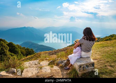 Mother and daughter looking at view of Lake Lugano, Balcone d'Italia, Italy Stock Photo