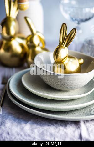 Festive Easter place setting with a golden bunny Stock Photo