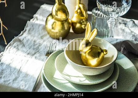Festive Easter place setting with a golden bunny Stock Photo