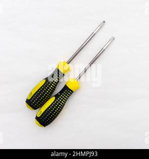 Tool for tightening screws and self-tapping screws. Screwdrivers with black and yellow handle. Stock Photo
