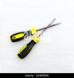 Tool for tightening screws and self-tapping screws. Screwdrivers with black and yellow handle. Stock Photo