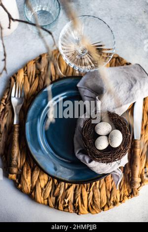 Easter place setting with Easter eggs in a bird's nest Stock Photo