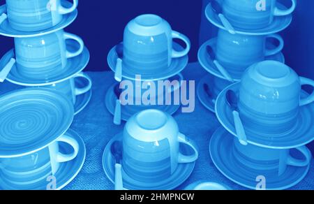 Stacks of cups and saucers in arctic blue color for backdrop or banner Stock Photo
