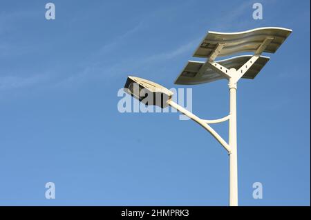 The photo of the solar panel was taken on an island in the Caribbean. The solar panel is located at the top, and the electric lamp is directly below. Stock Photo