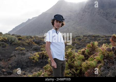 Portrait of a teenager against the backdrop of the Los Gigantes cliffs. Tenerife. Canary Islands. Spain. Stock Photo