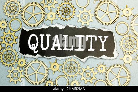 The word Quality in white text on a blackboard with a border of jigsaw puzzle pieces. Stock Photo