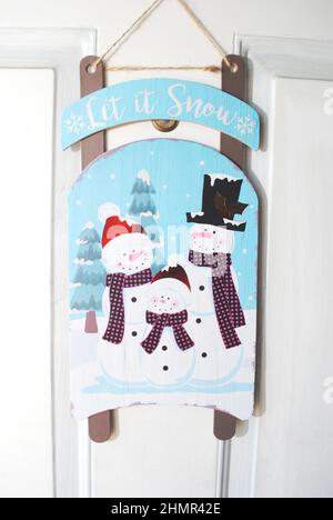 Christmas or Winter Decoration of a Snowmen Family Hanging on a Door Stock Photo