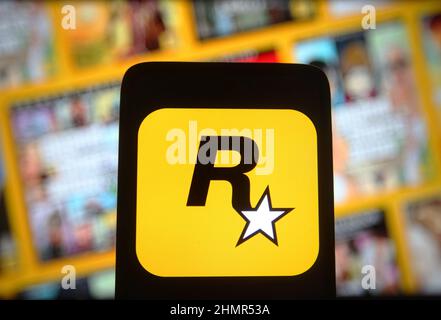 In this photo illustration a Rockstar Games logo seen displayed on a  smartphone with video games cover in the background. (Photo by Thiago  Prudencio / SOPA Images/Sipa USA Stock Photo - Alamy