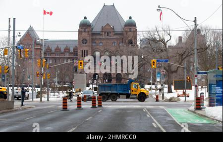 Toronto, Canada. 11th Feb, 2022. Police block a street with a truck in front of the Ontario Legislative Building in Toronto, Canada, Feb. 11, 2022. Ontario Premier Doug Ford declared Friday a state of emergency in response to ongoing blockades caused by the truck convoy protests in Ottawa and Windsor in Canada's Ontario province. Credit: Zou Zheng/Xinhua/Alamy Live News Stock Photo