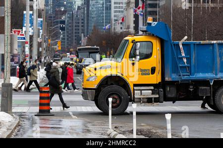 Toronto, Canada. 11th Feb, 2022. Police block a street with a truck in front of the Ontario Legislative Building in Toronto, Canada, Feb. 11, 2022. Ontario Premier Doug Ford declared Friday a state of emergency in response to ongoing blockades caused by the truck convoy protests in Ottawa and Windsor in Canada's Ontario province. Credit: Zou Zheng/Xinhua/Alamy Live News Stock Photo