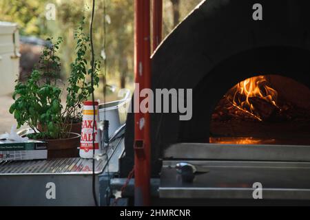 https://l450v.alamy.com/450v/2hmrcnr/gunbower-victoria-australia-february-5-2022-outdoor-wood-fired-pizza-oven-at-party-with-table-salt-and-herbs-2hmrcnr.jpg