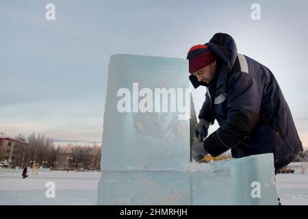 Worker with a chisel in his hand at a construction site Stock Photo
