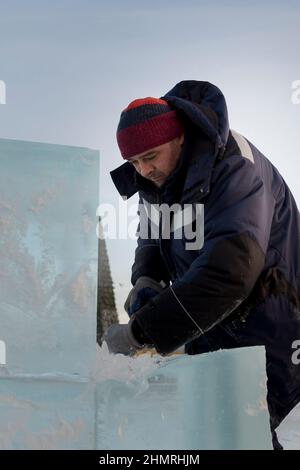 Worker with a chisel in his hand at a construction site Stock Photo
