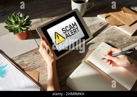 Scam alert detecting warning. Notification on device screen. Stock Photo