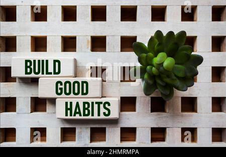 Symbol of good habits. Wooden blocks with the words build good habits. Beautiful vintage wooden background, Concept of business, psychology and buildi Stock Photo