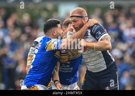 Leeds, UK. 12th Feb, 2022. Oliver Holmes #12 of Warrington Wolves is tackled by Rhyse Martin #12 of Leeds Rhinos and Richie Myler #16 of Leeds Rhinos in Leeds, United Kingdom on 2/12/2022. (Photo by Mark Cosgrove/News Images/Sipa USA) Credit: Sipa USA/Alamy Live News Stock Photo