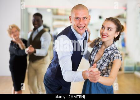 Man and woman dancing waltz in studio Stock Photo