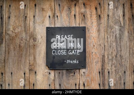 Hand painted sign on a wooden gate. Stock Photo