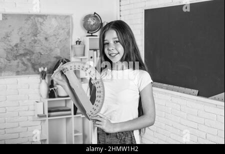 exact sciences. child hold protractor ruler. back to school. formal education in modern life. home schooling. childhood development. get knowledge Stock Photo