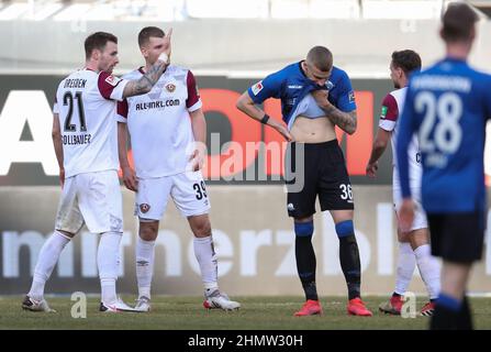 Germany. 12th Feb, 2022. 12 February 2022, North Rhine-Westphalia, Paderborn: Soccer: 2nd Bundesliga, SC Paderborn 07 - Dynamo Dresden, Matchday 22 at Benteler Arena. Paderborn's Felix Platte (3rd from right) looks disappointed at the end of the match. Dresden's Michael Sollbauer (l) and Kevin Ehlers (2nd from left) applaud. Photo: Friso Gentsch/dpa - IMPORTANT NOTE: In accordance with the requirements of the DFL Deutsche Fußball Liga and the DFB Deutscher Fußball-Bund, it is prohibited to use or have used photographs taken in the stadium and/or of the match in the form of sequence pictures an Stock Photo