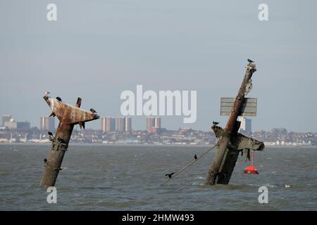 Sheerness, Kent, UK. 12th Feb, 2022. The wreck of the SS Richard Montgomery that sunk in August 1944 in the Thames Estuary off Sheerness Kent. The ship ran aground during WW2 and still contains 1,400 tonnes of explosives and now 78 years after the sinking Royal Naval bomb disposal experts have been called in to make the wreck safe by initially removing the ships masts that have remained visible within the exclusion zone placed around the vessel. Credit: MARTIN DALTON/Alamy Live News Stock Photo