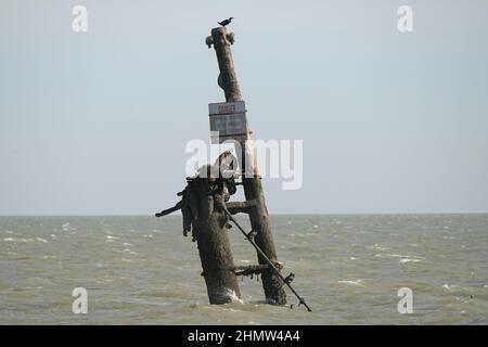 Sheerness, Kent, UK. 12th Feb, 2022. The wreck of the SS Richard Montgomery that sunk in August 1944 in the Thames Estuary off Sheerness Kent. The ship ran aground during WW2 and still contains 1,400 tonnes of explosives and now 78 years after the sinking Royal Naval bomb disposal experts have been called in to make the wreck safe by initially removing the ships masts that have remained visible within the exclusion zone placed around the vessel. Credit: MARTIN DALTON/Alamy Live News Stock Photo