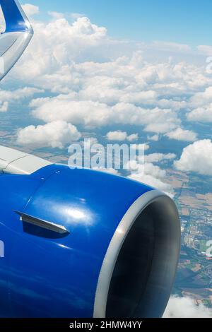 View of airplane engine and clouds over the sea at sunset through ...