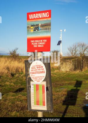 A warning sign for cars crossing the causeway to Holy Island, Northumberland, UK. Stock Photo