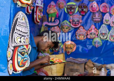 Purulia, Ayodhya hill, West Bengal, India - 14th December 2021: a tribal man making colorful traditional chhau masks Stock Photo