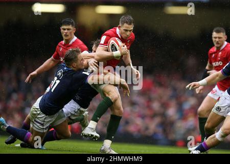 Cardiff, UK. 12th Feb, 2022. Liam Williams of Wales is tackled by Scotland's Chris Harris and Duhan Van Der Merwe (11). Guinness Six Nations championship 2022 match, Wales v Scotland at the Principality Stadium in Cardiff on Saturday 12th February 2022. pic by Andrew Orchard/Andrew Orchard sports photography/ Alamy Live News Credit: Andrew Orchard sports photography/Alamy Live News Stock Photo
