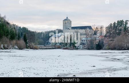 Hrad Kost panorama. Castle Kost in winter landscape, view over frozen Bily pond. Travel in Czech Republic Stock Photo