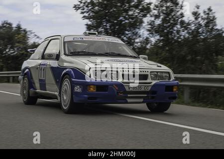 Closeup of a Ford Sierra RS500 running fast in the asphalt rally Stock Photo