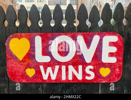 Asheville, North Carolina, USA. 12th Feb, 2022. Love WinsÃ¢â‚¬Â is seen painted on a wood fence in downtown Asheville, North Carolina, shortly before ValentineÃ¢â‚¬â„¢s Day, on Saturday February 12, 2022. (Credit Image: © Mark Hertzberg/ZUMA Press Wire) Stock Photo