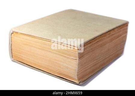 Old book with yellowed pages and a cloth cover. Thick book isolated on a white background. Stock Photo