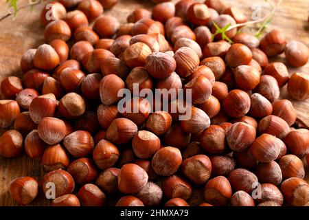 a hazelnuts nuts in shell on wooden board. Stock Photo